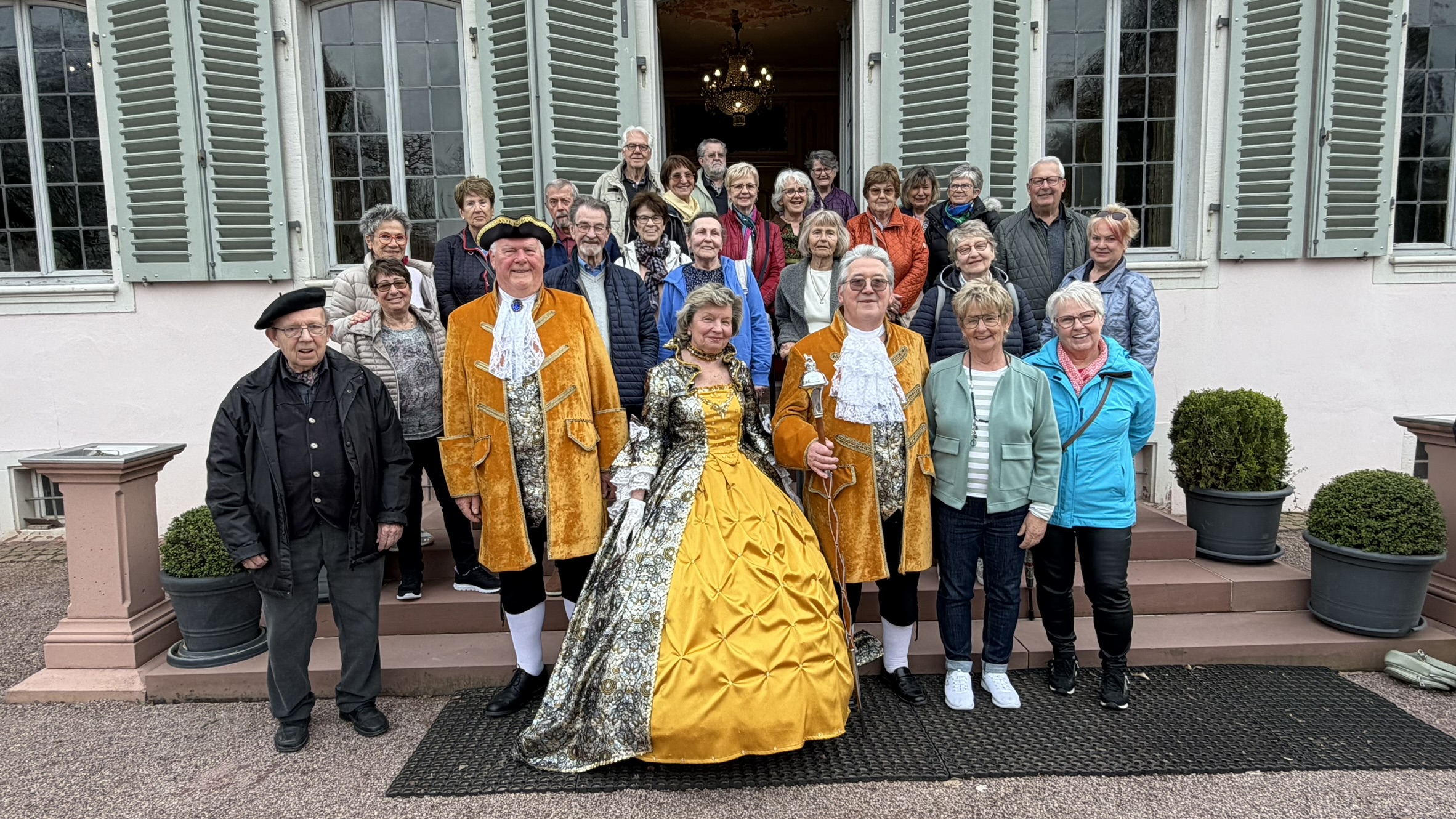 Ausfl�gler auf der Treppe im Schloss Braunshardt. Rechts neben dem Rokoko-Dreigestirn steht Marion Th�rmer, der Initiatorin der Zeitreise. Foto: Roswita Schneider.